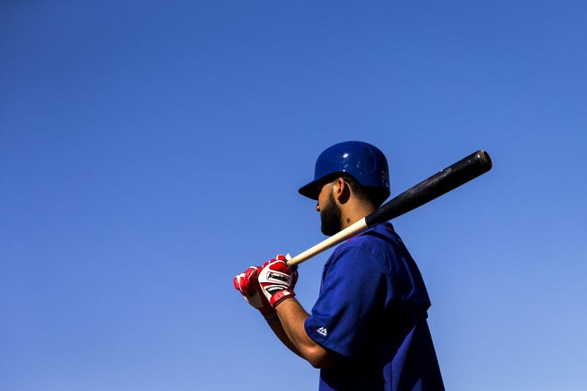 Texas Rangers outfielder Nomar Mazara waits to take his turn in the batting cage during a...