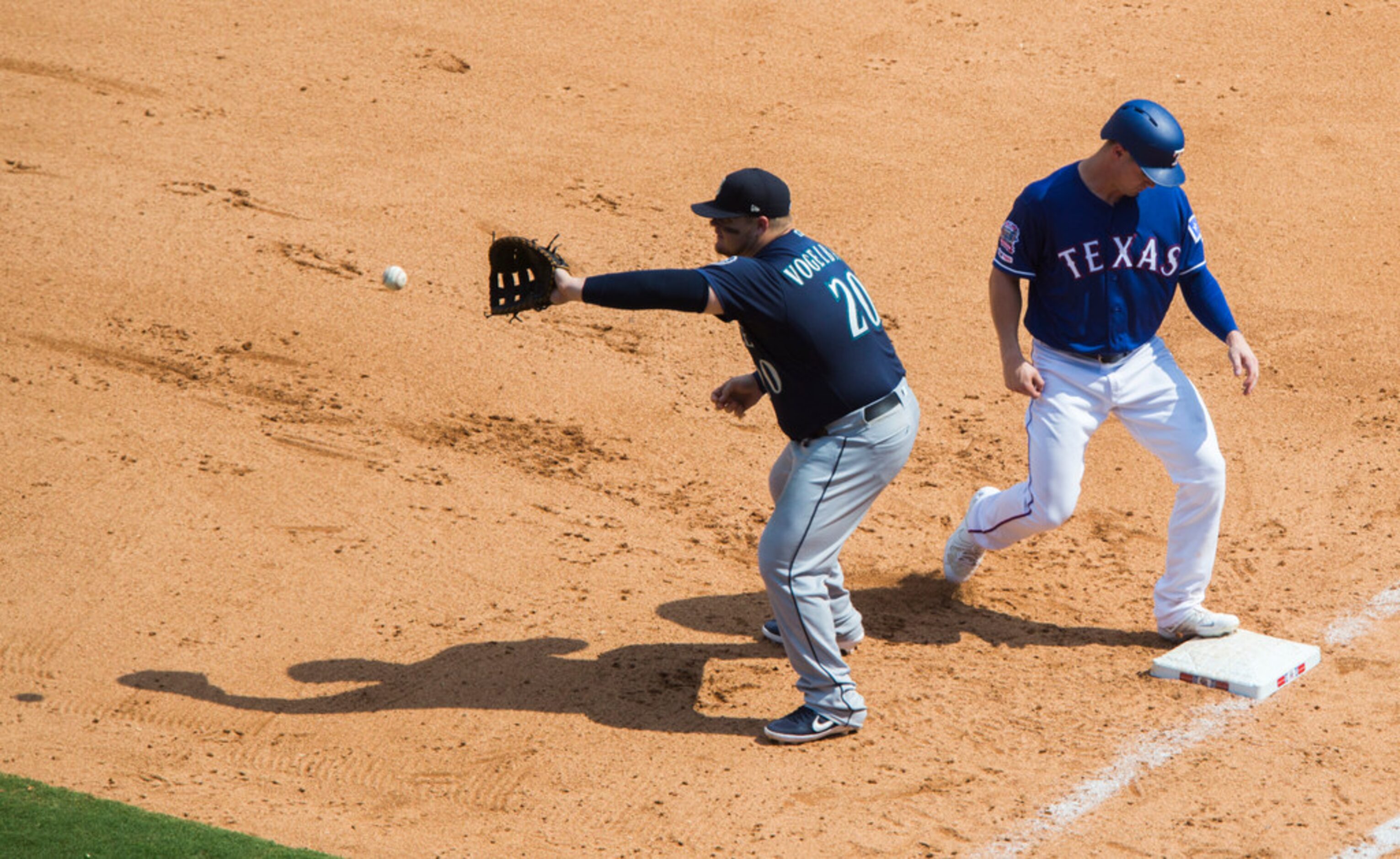 Texas Rangers left fielder Scott Heineman (16) is safe at first ahead of a throw to Seattle...