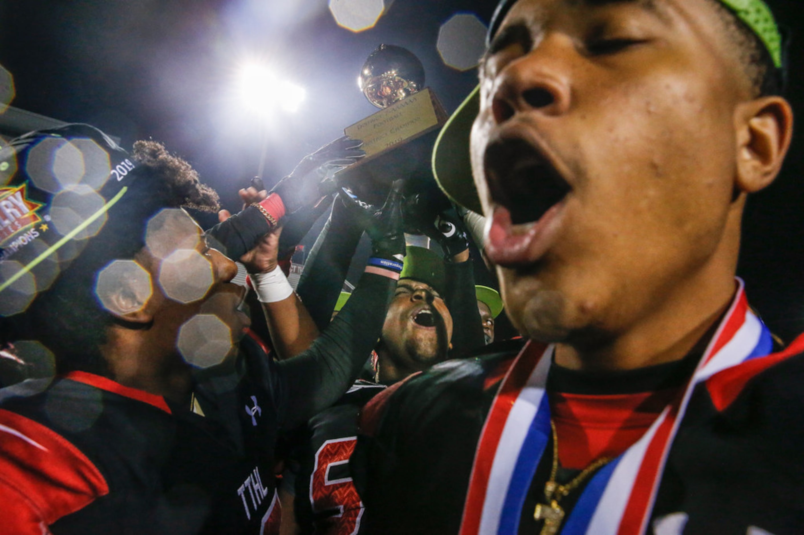 The Cedar Hill Longhorns celebrate their 7-6A district championship win over the DeSoto...