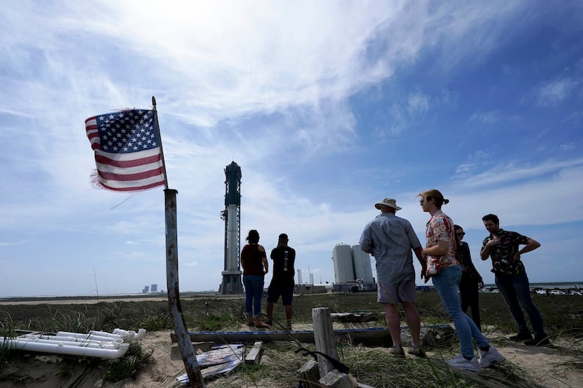 Onlookers watch as SpaceX's Starship, the world's biggest and most powerful rocket gets...