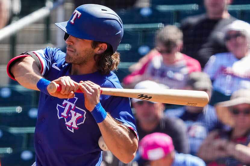 Texas Rangers infielder Josh Smith is hit in the elbow by a pitch during the second inning...