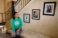 Angela Jones poses for a photo as sitting by photographs of her children, TJ Jones, around...