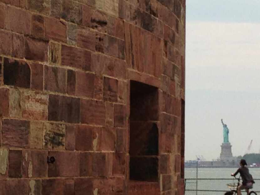 Castle Williams overlooks the busy New York harbor and the Statue of Liberty.
