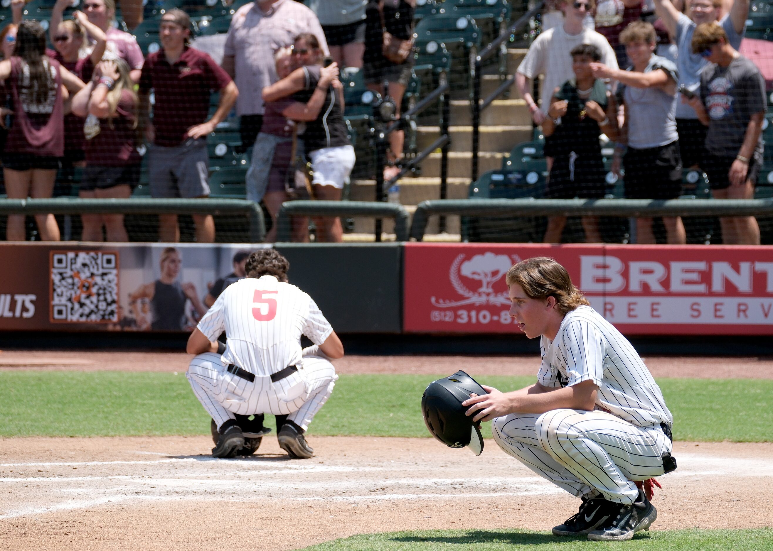 Just short of home plate Argyle Jackson Blank, (5), and JC Davis, (4), look on as Magnolia...