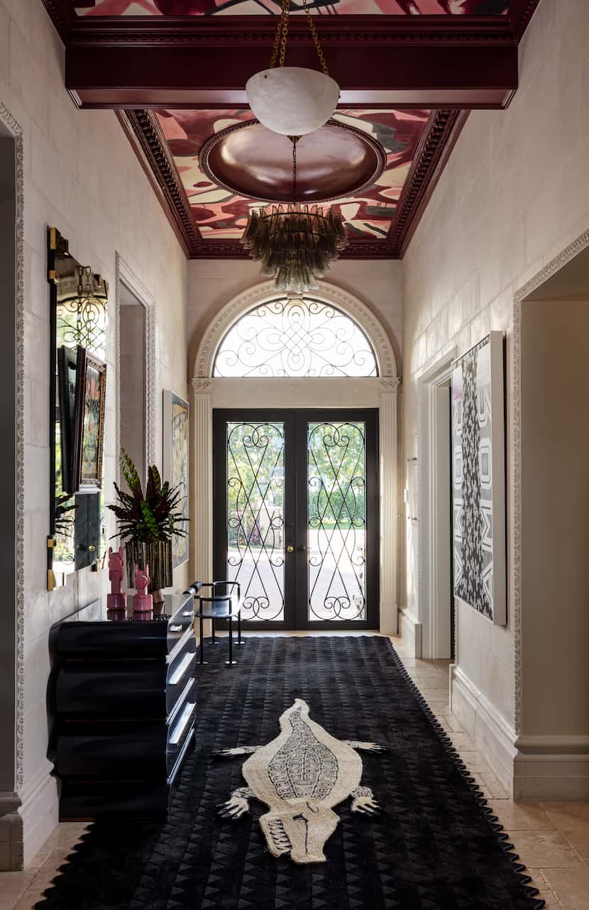 An entry way features a wallpapered ceiling.