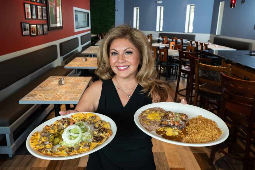 Norma Valles, co-owner of Casita Tex-Mex restaurant, holds dishes of fajita nachos, left,...