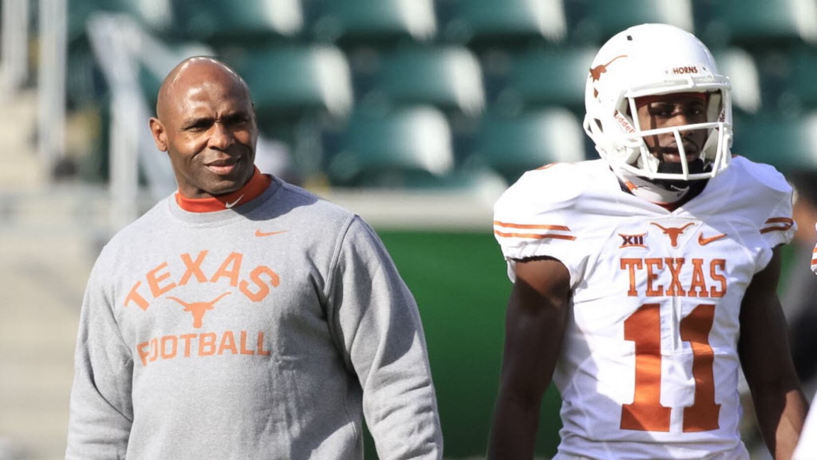 Texas Head Coach Charlie Strong watches his players during the warm-up before the kick-off...