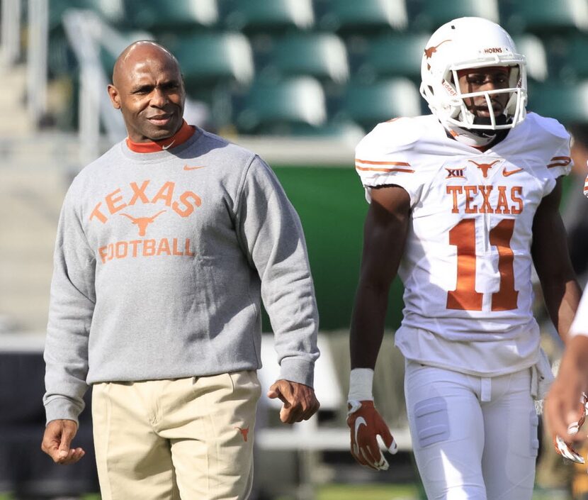 Texas Head Coach Charlie Strong watches his players during the warm-up before the kick-off...