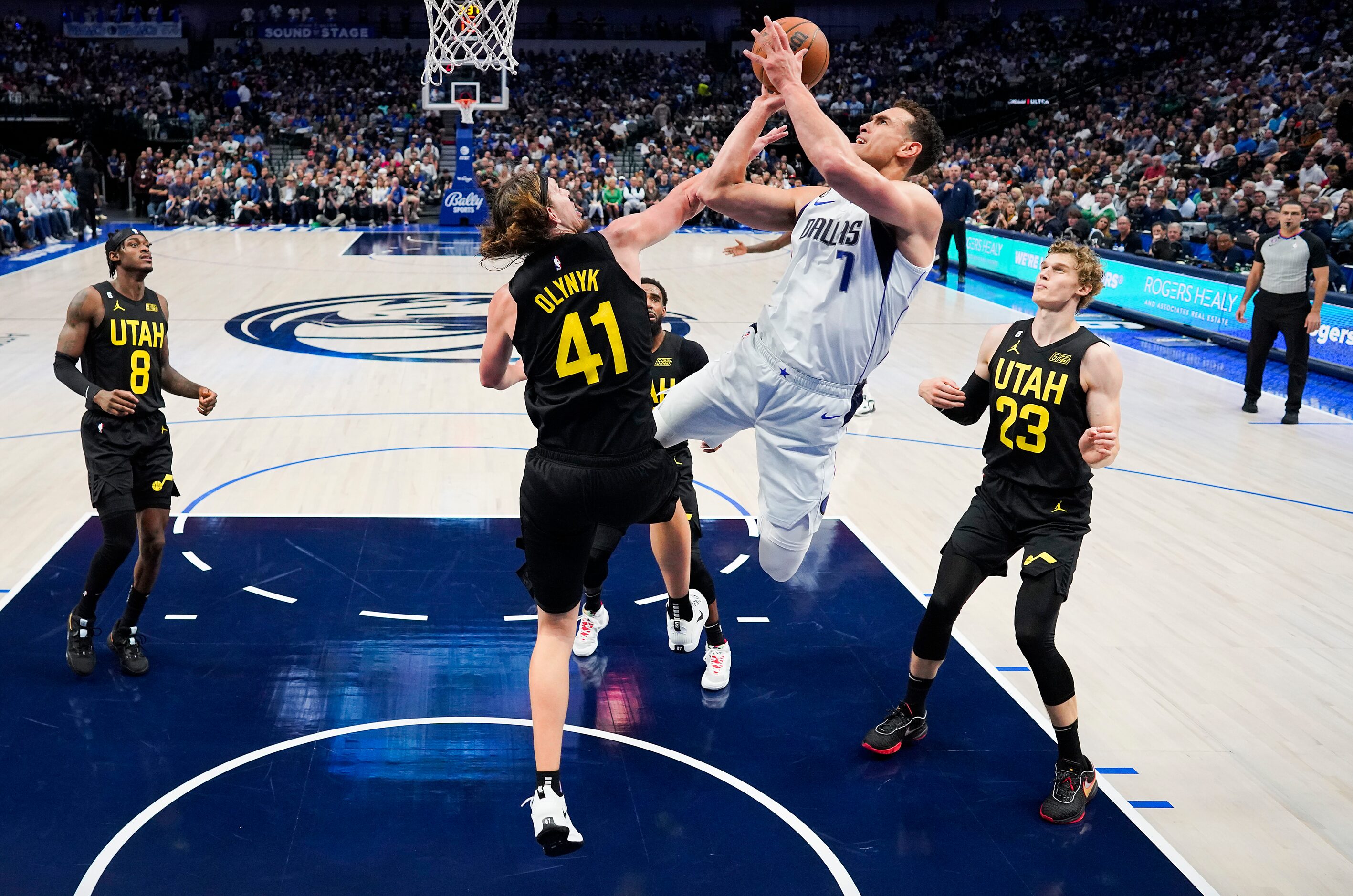 Dallas Mavericks center Dwight Powell (7) shoots against Utah Jazz forward Kelly Olynyk (41)...