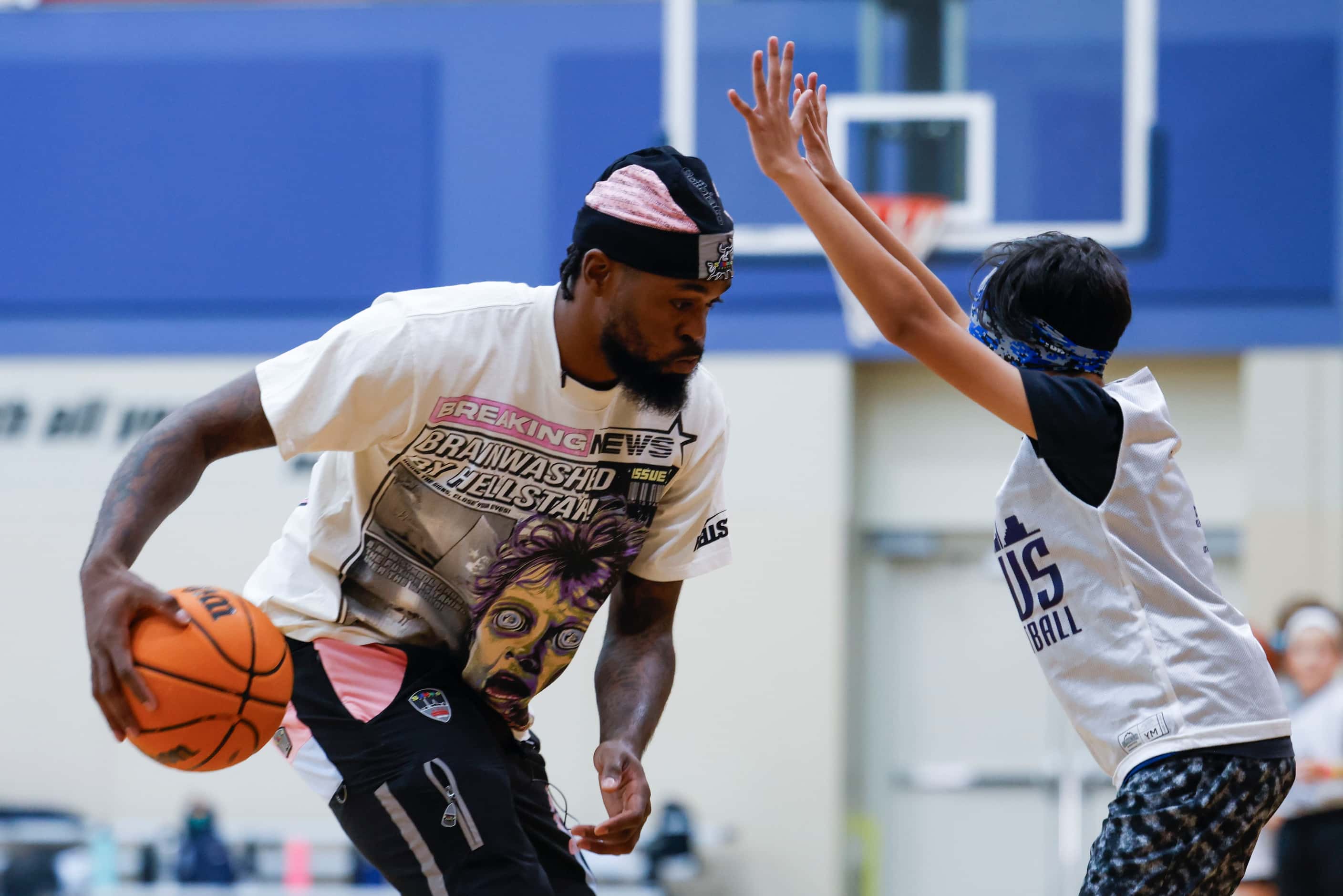 Dallas Mavericks’ Naji Marshall, play ball with young basketball campers during a Hoop Camp,...