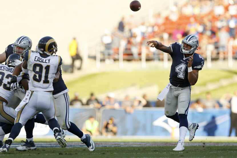 Dallas Cowboys quarterback Dak Prescott (4) tosses a second quarter in their first preseason...