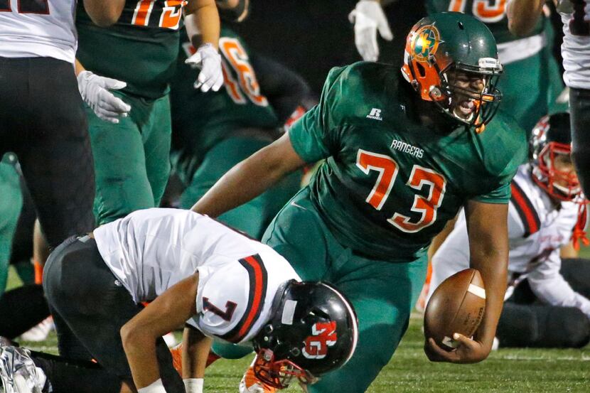 Naaman Forest lineman Nico Ezidore (73) comes up smiling after running for a first down, as...