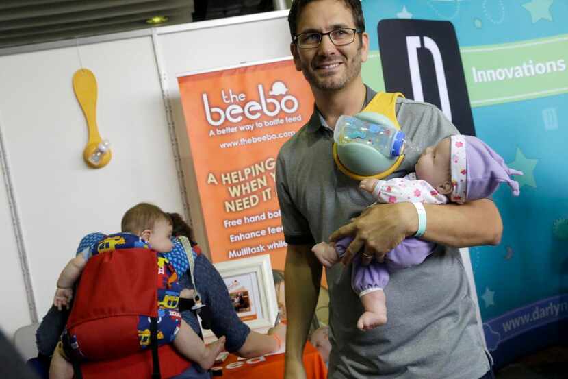 
Look, Dad, no hands. Martin Hill showed off The Beebo for hands-free bottle feeding at the...