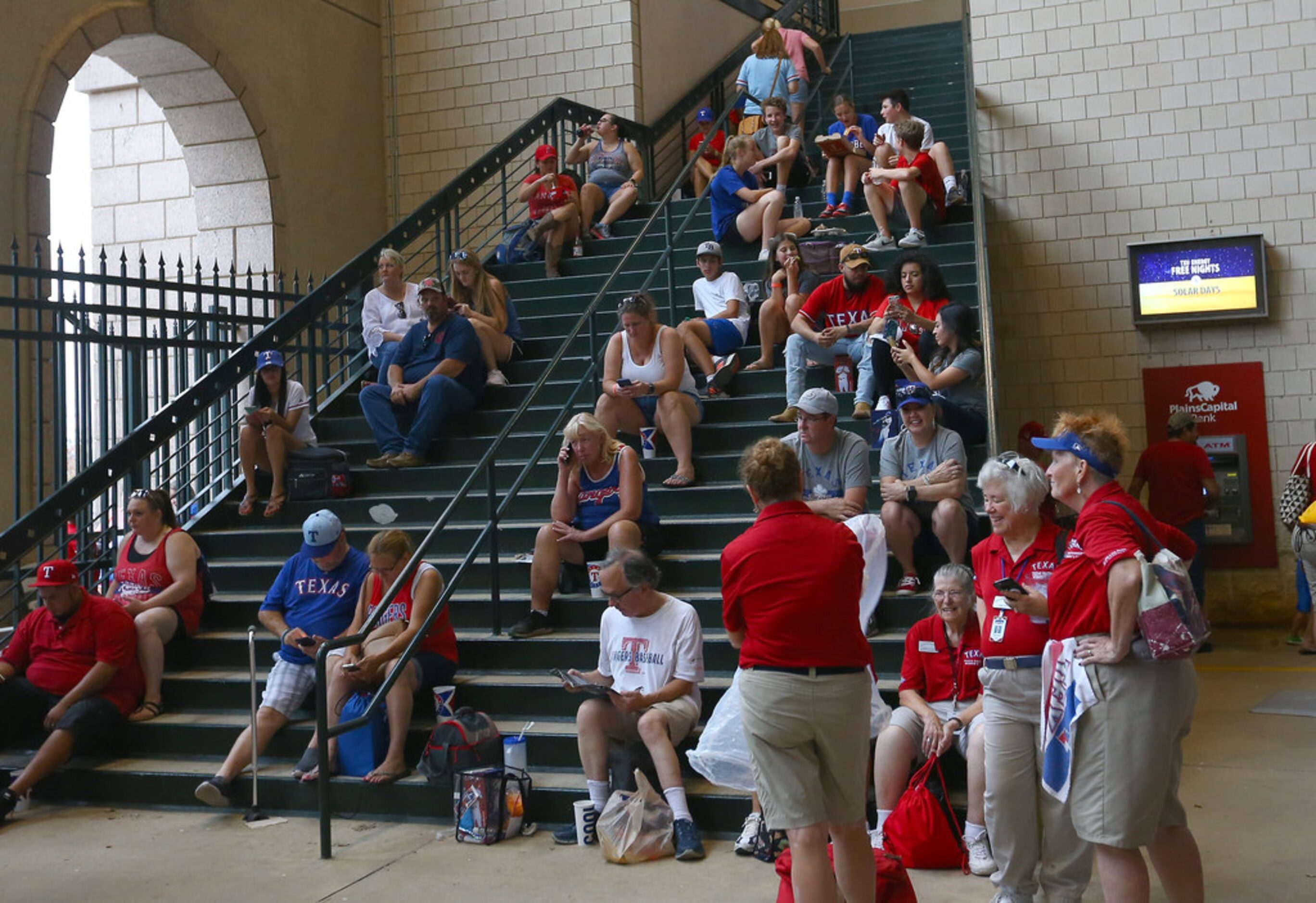 ARLINGTON, TX - AUGUST 18: Fans taking shelter from the grandstands during a rain delay...