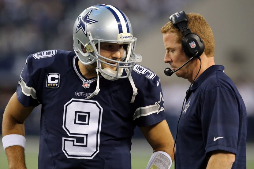 Dallas Cowboys quarterback Tony Romo (9) and Dallas Cowboys head coach Jason Garrett talk...