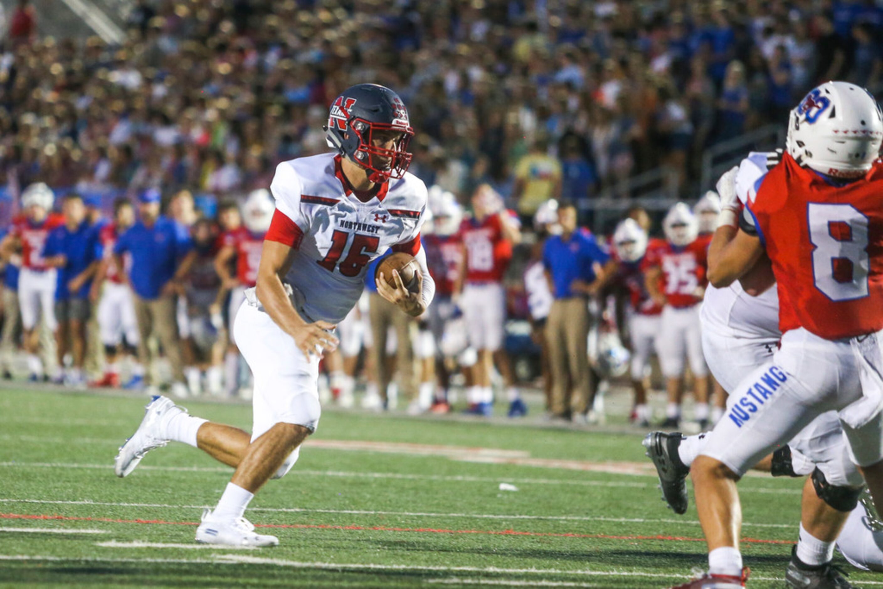 Northwest quarterback Austin Ahmad (15) carries the ball for a touchdown during the first...