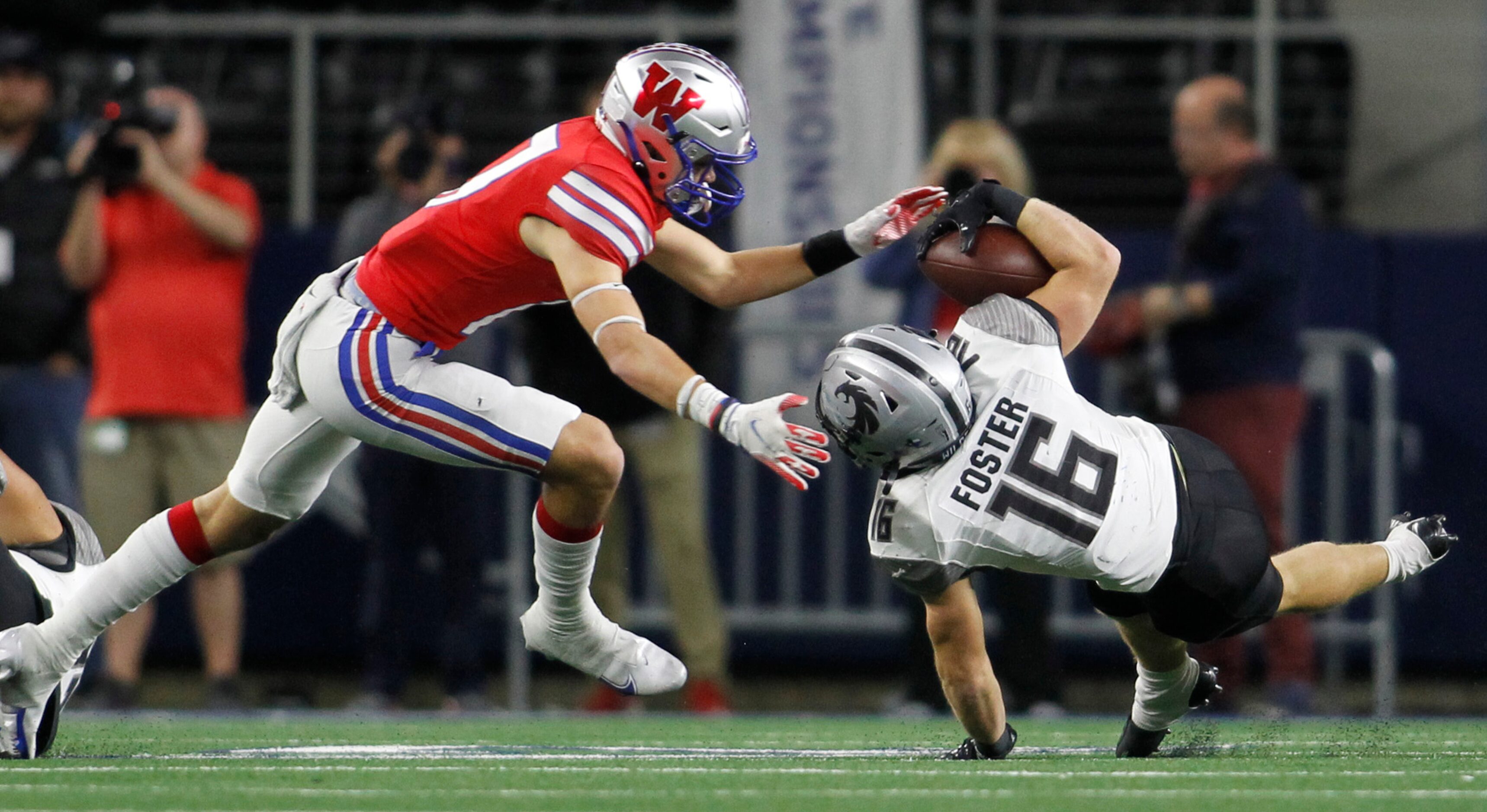 Denton Guyer running back Jackson Foster (16) is tripped up before reaching Austin Westlake...