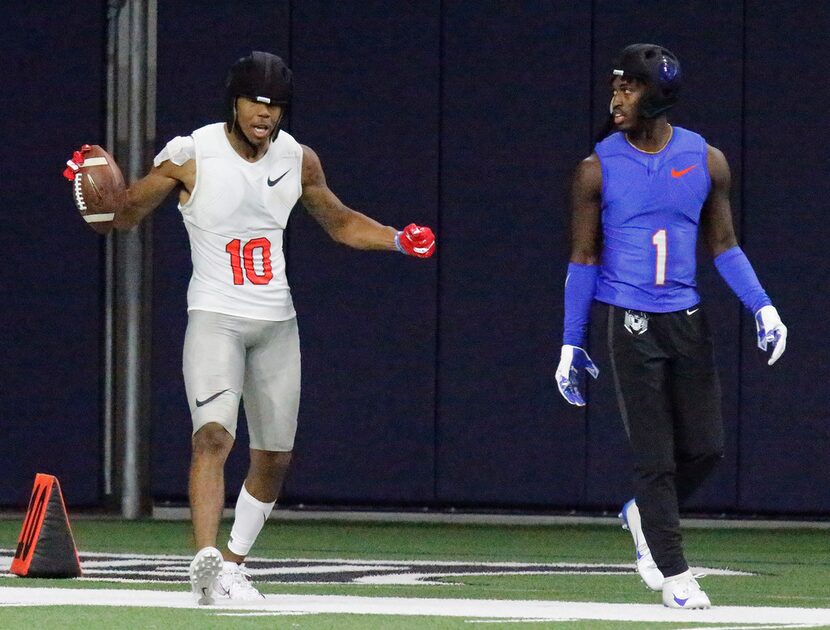 Wide receiver Theo Wease, Jr. (left) celebrates while defensive back Marquez Beason from ...