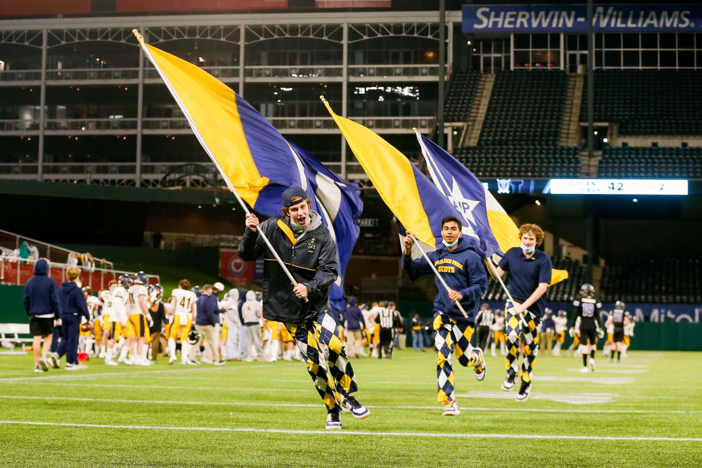 Highland Park flag runners run the field after a touchdown in the fourth quarter of a Class...