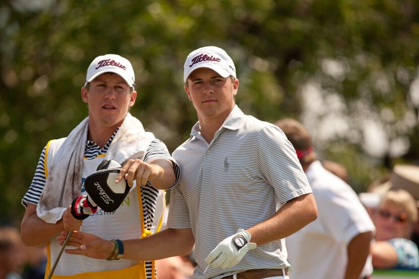 IRVING, TX - MAY 27: Jordan Spieth takes a club from caddie Kramer Hickok during the second...
