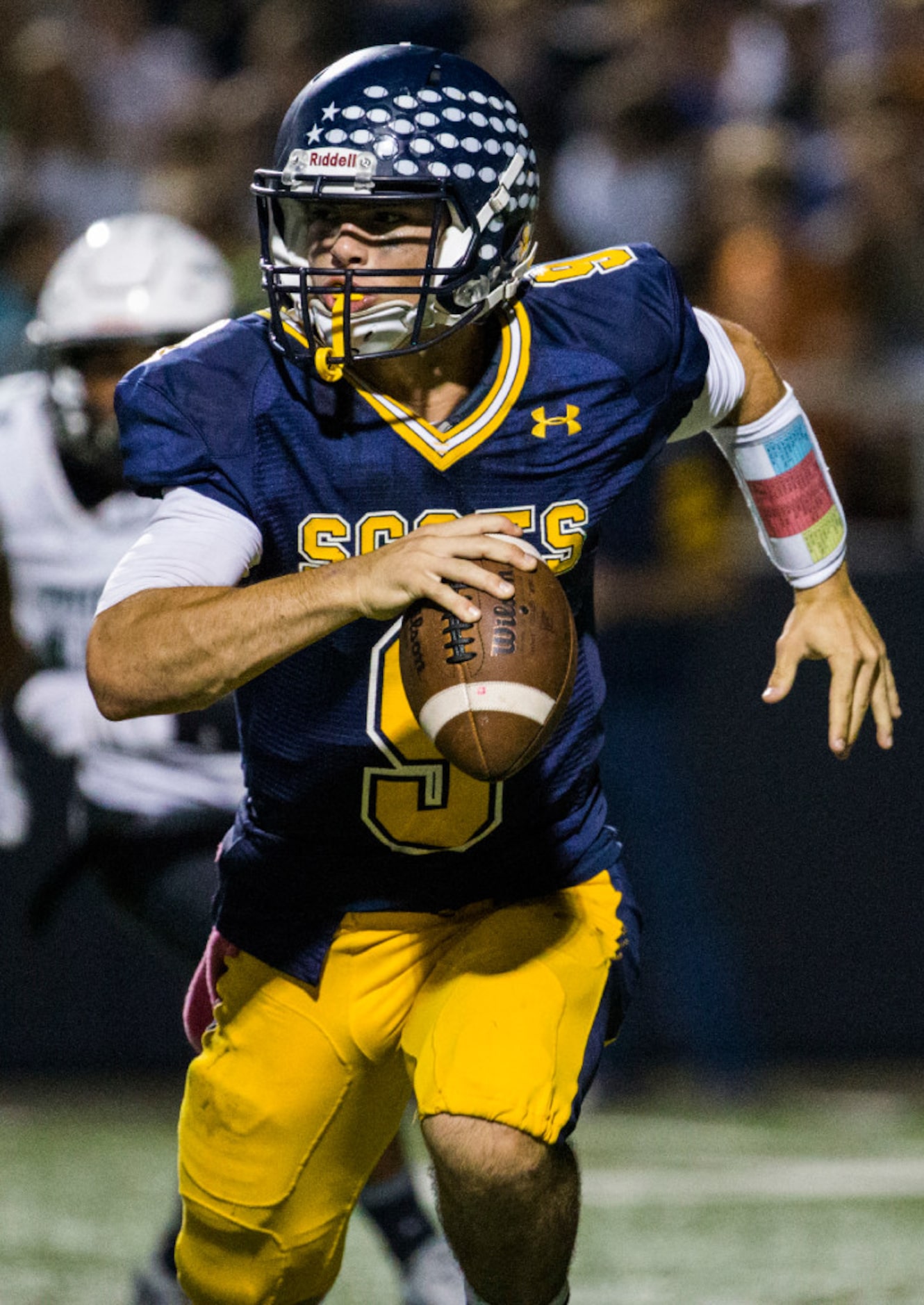 Highland Park quarterback John Stephen Jones (9) scrambles to find a receiver during the...