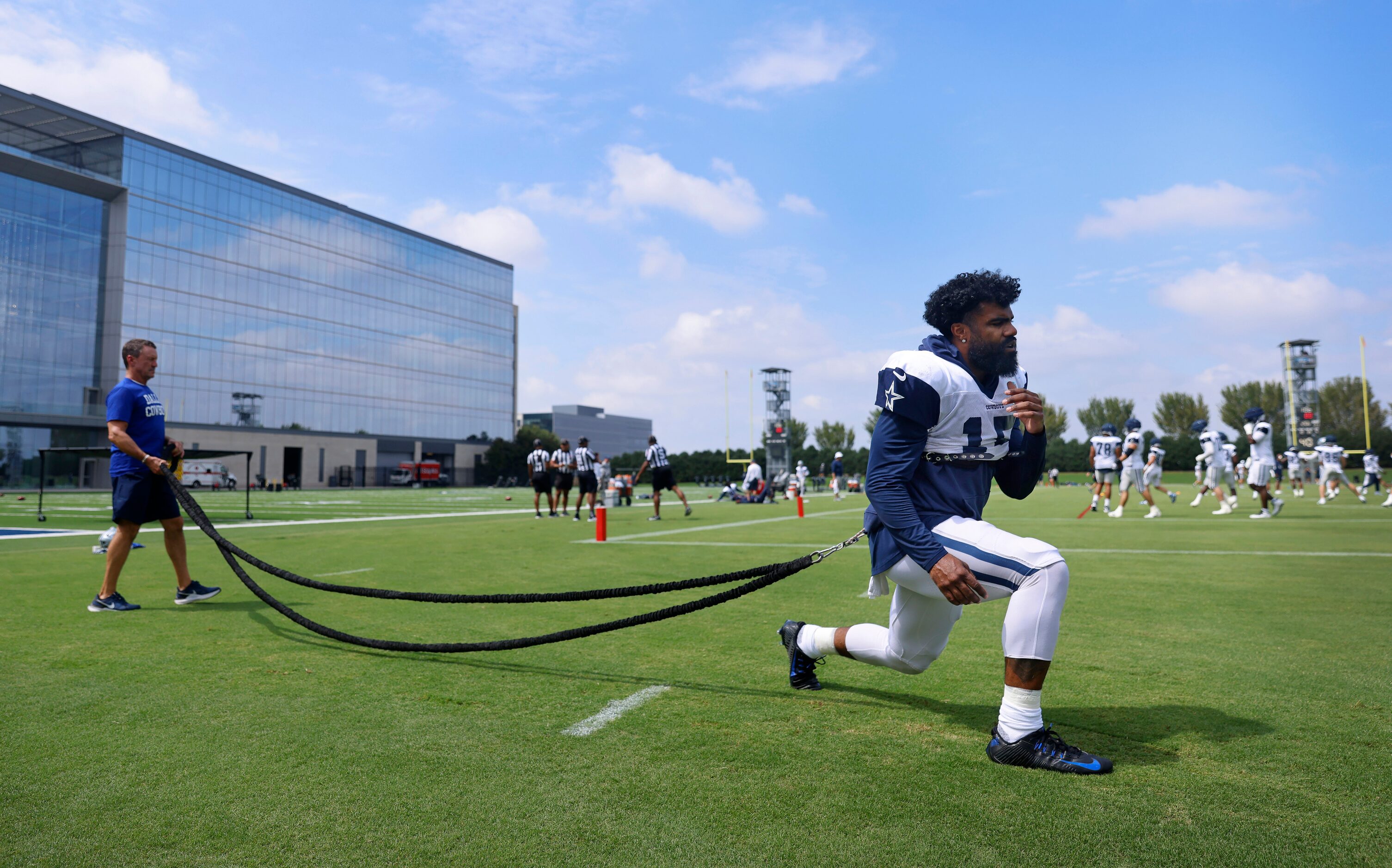 Dallas Cowboys running back Ezekiel Elliott (15) works out on the exercise cord at practice...