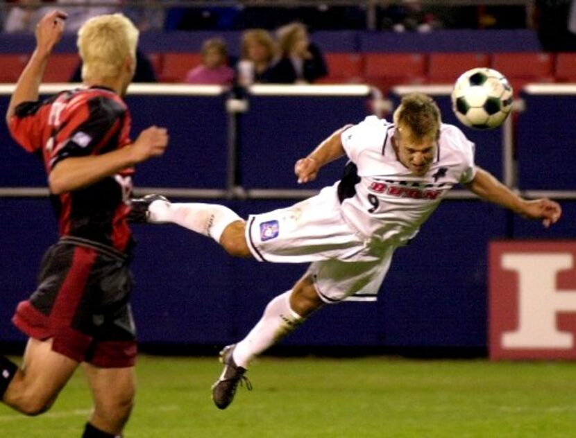 Dallas Burn forward Jason Kreis, right, heads the ball into the net for a goal as New...