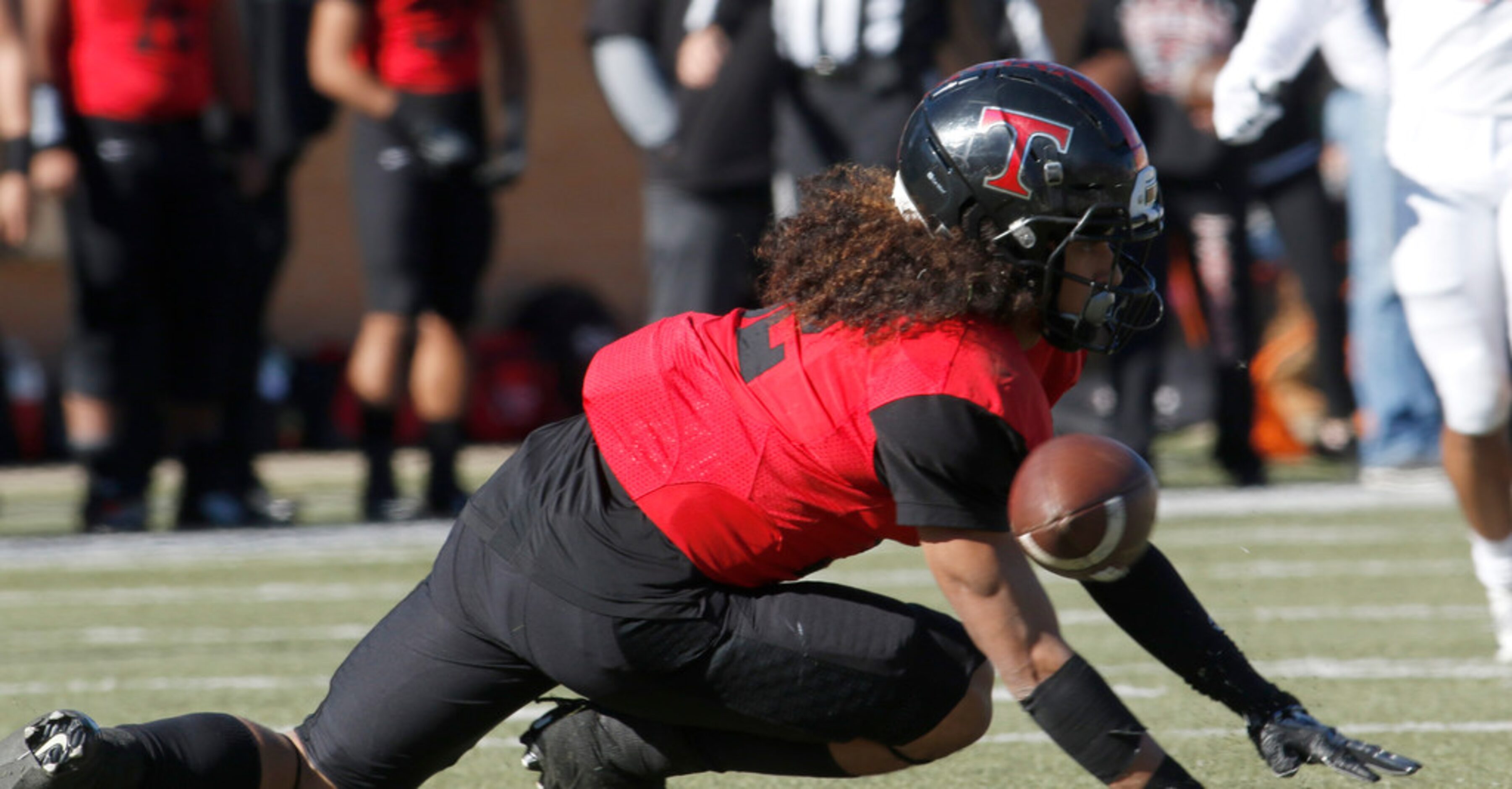 Euless Trinity's Sebastian Tauaalo (32) fumbles an attempted punt return which was recovered...