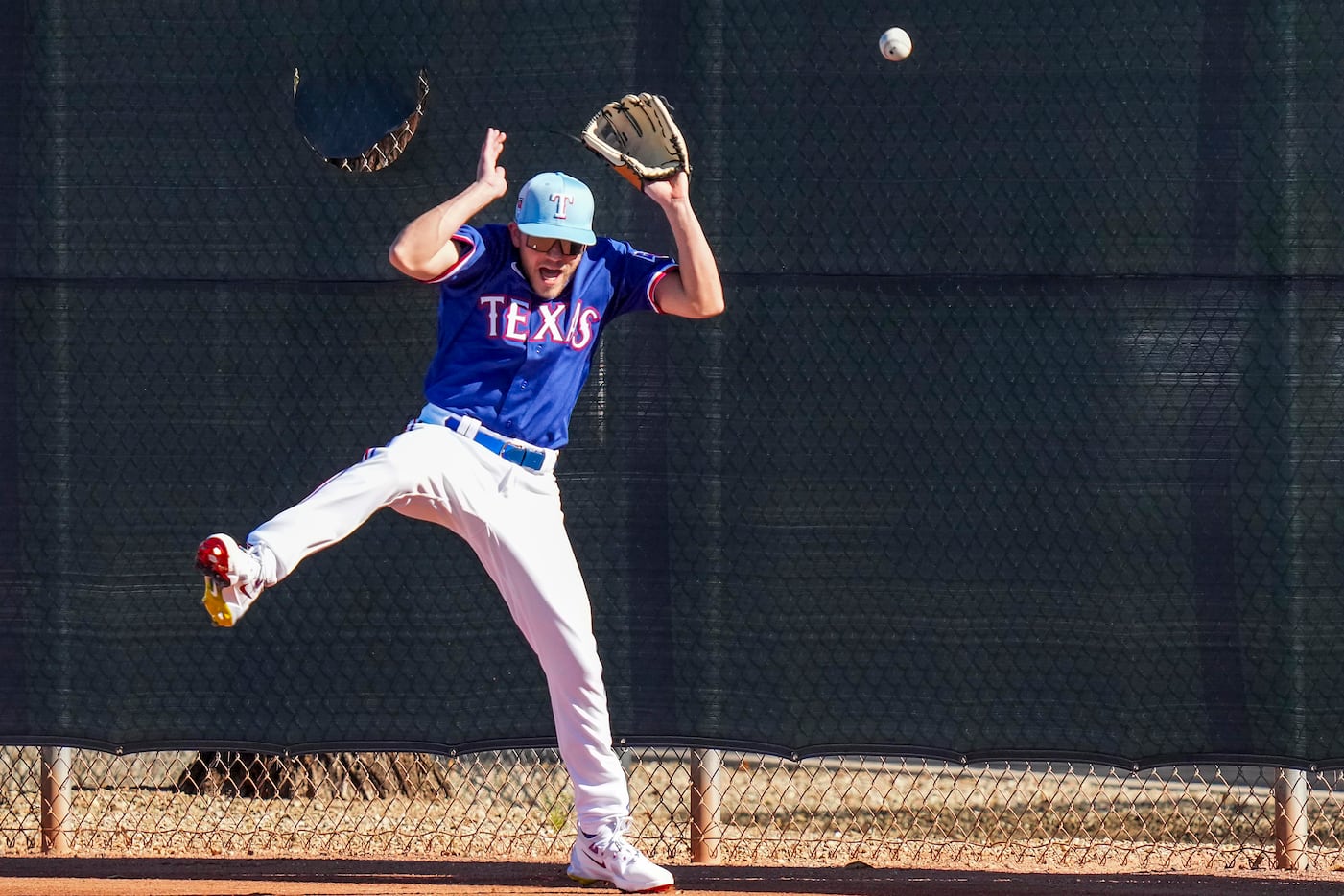 Kevin Sparkman of Dude Perfect tries to make a catch at the outfield wall while shagging...