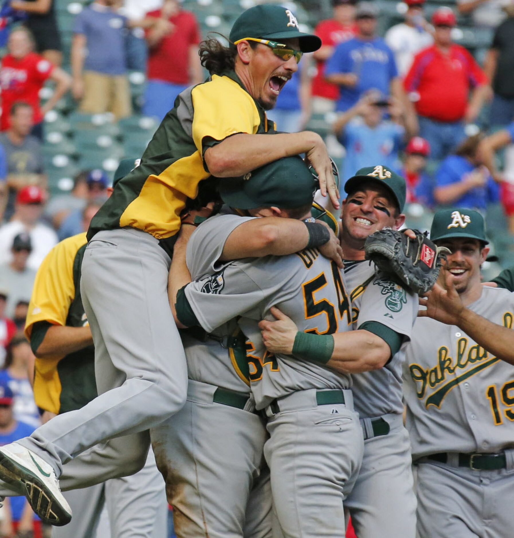 Oakland A's pitcher jeff Samardzija, left, and other teammates embrace starting pitcher...