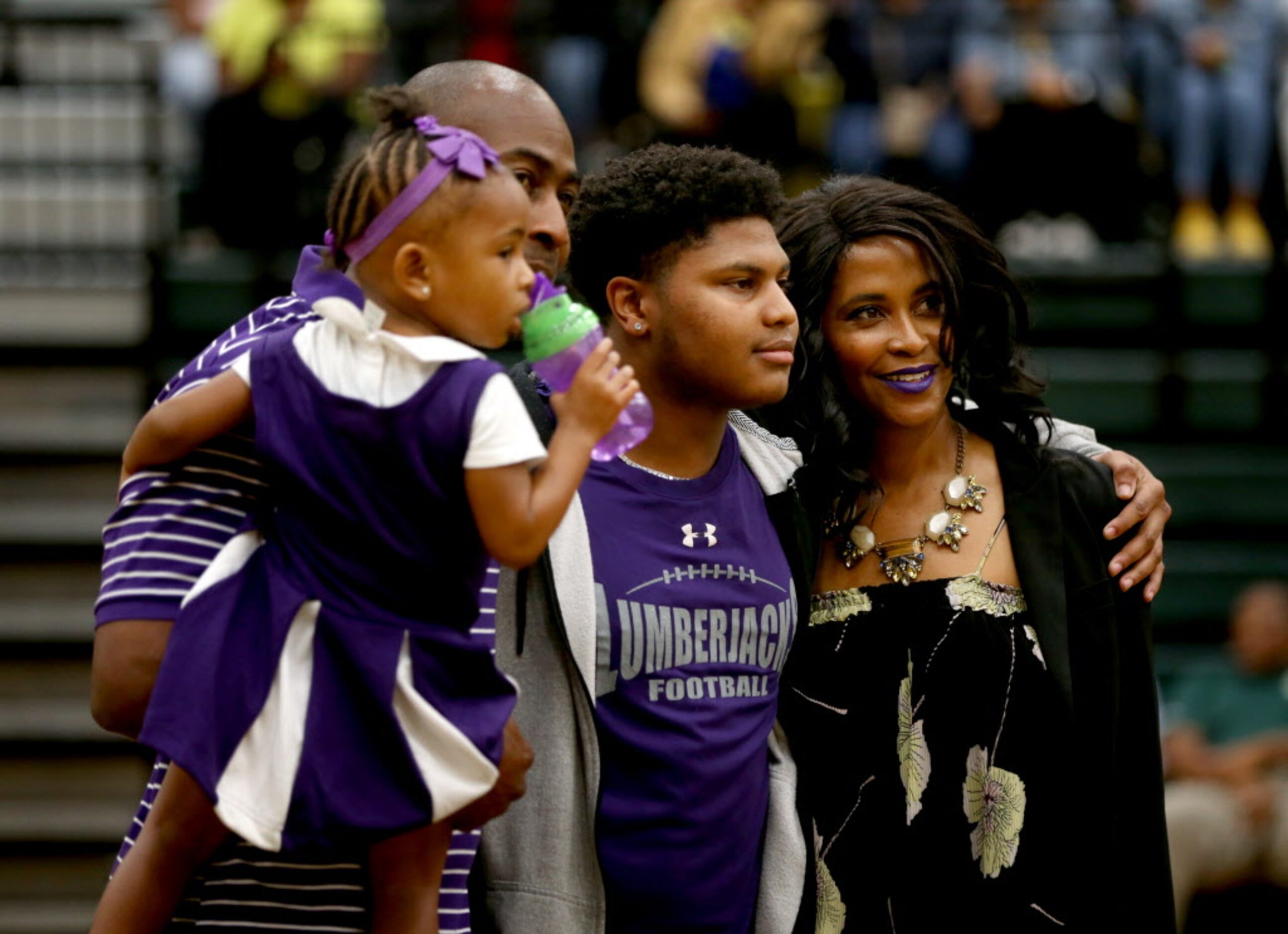 Running back Terreance Shaw poses for a photograph with his family before signing with...