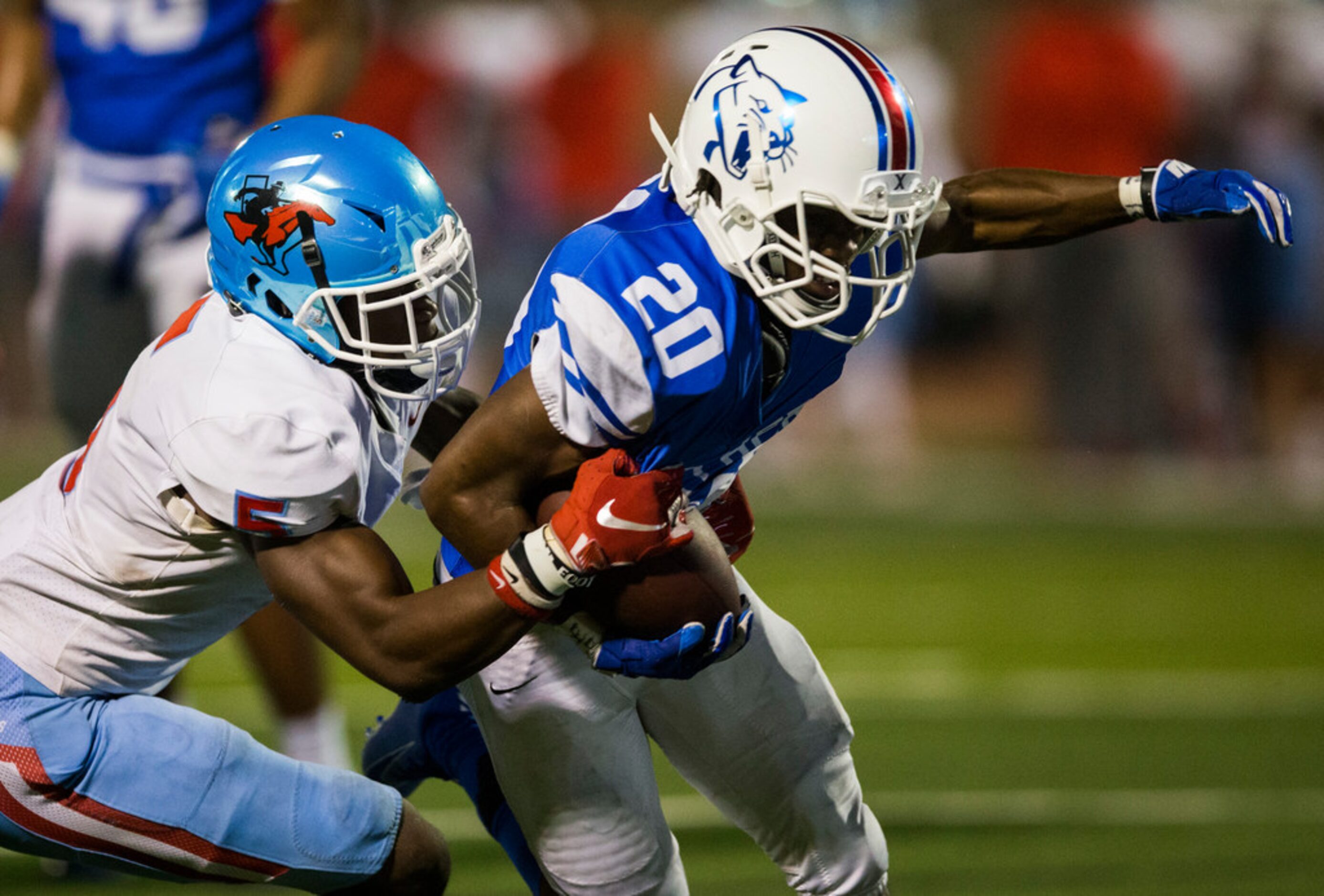 Duncanville running back Cameron Gray (20) is tackled by Skyline defensive back Isaiah...