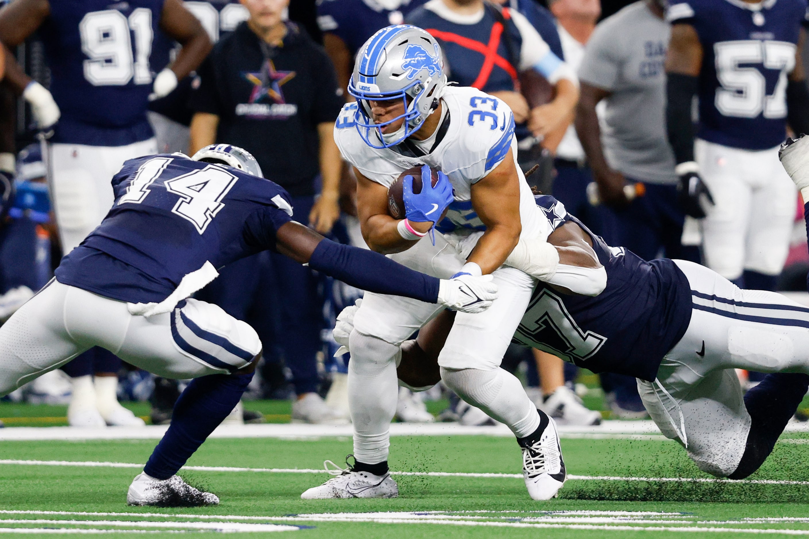 Detroit Lions running back Sione Vaki (33) is tackled by Dallas Cowboys safety Markquese...