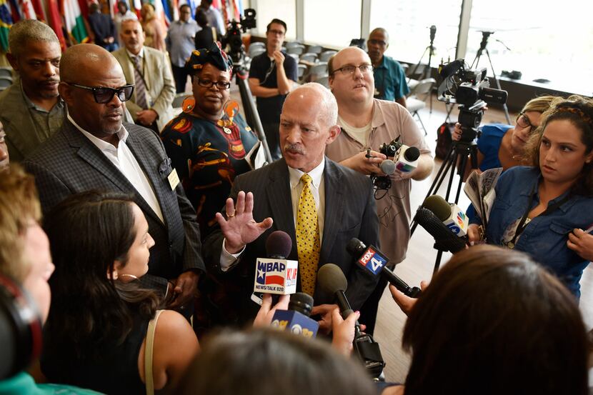 Dallas District Attorney John Creuzot is interviewed by reporters after a press conference...