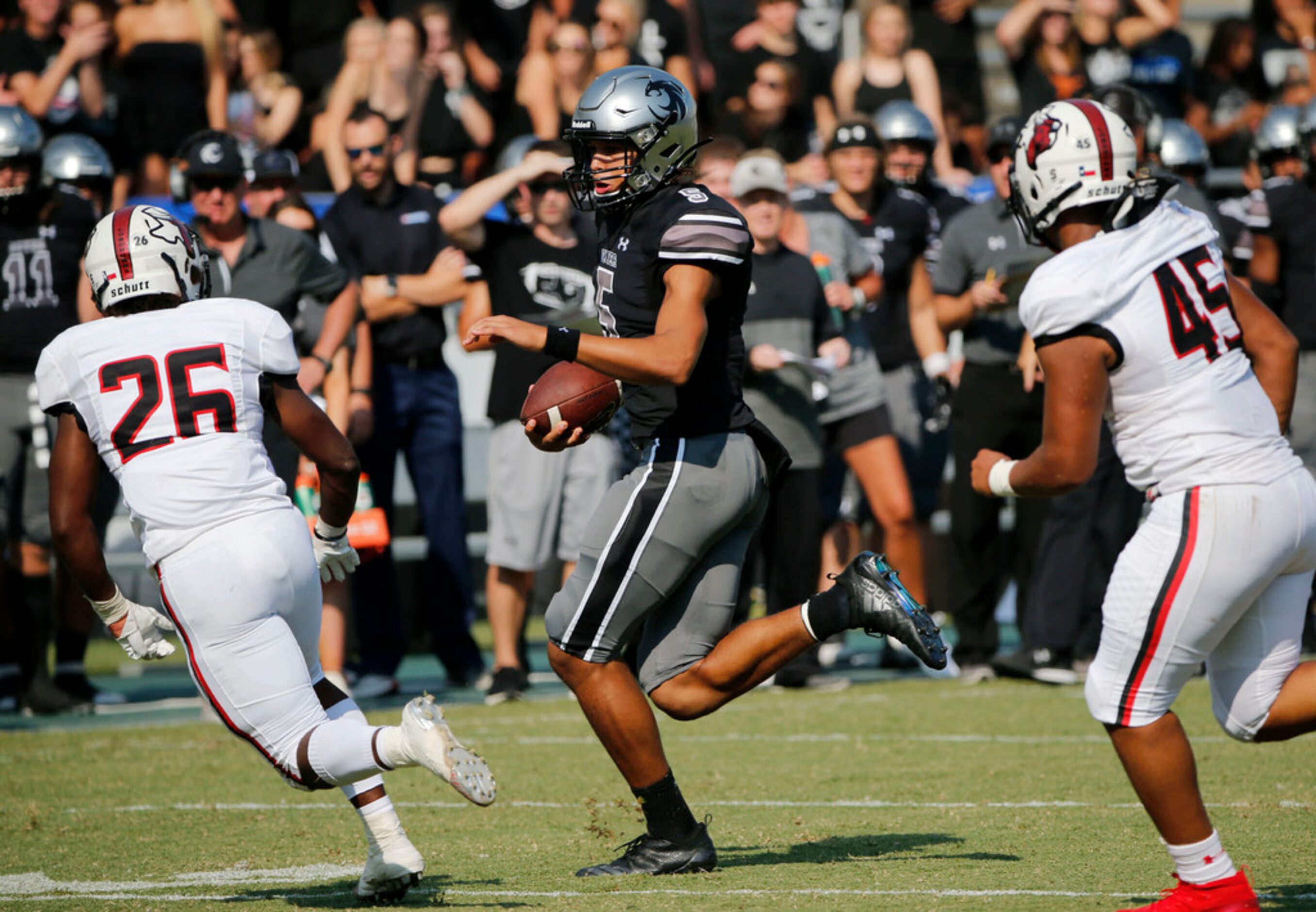 Denton Guyer quarterback Eli Stowers (50) tries to run past Cedar Hill defenders Demari Ward...