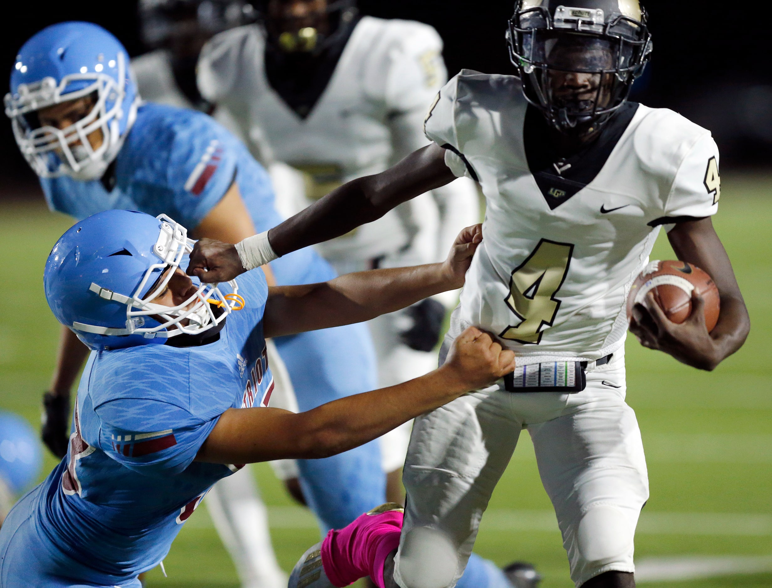 Pinkston wide receiver J'Marcus Sloan (4) gives a stiff arm to Thomas Jefferson linebacker...