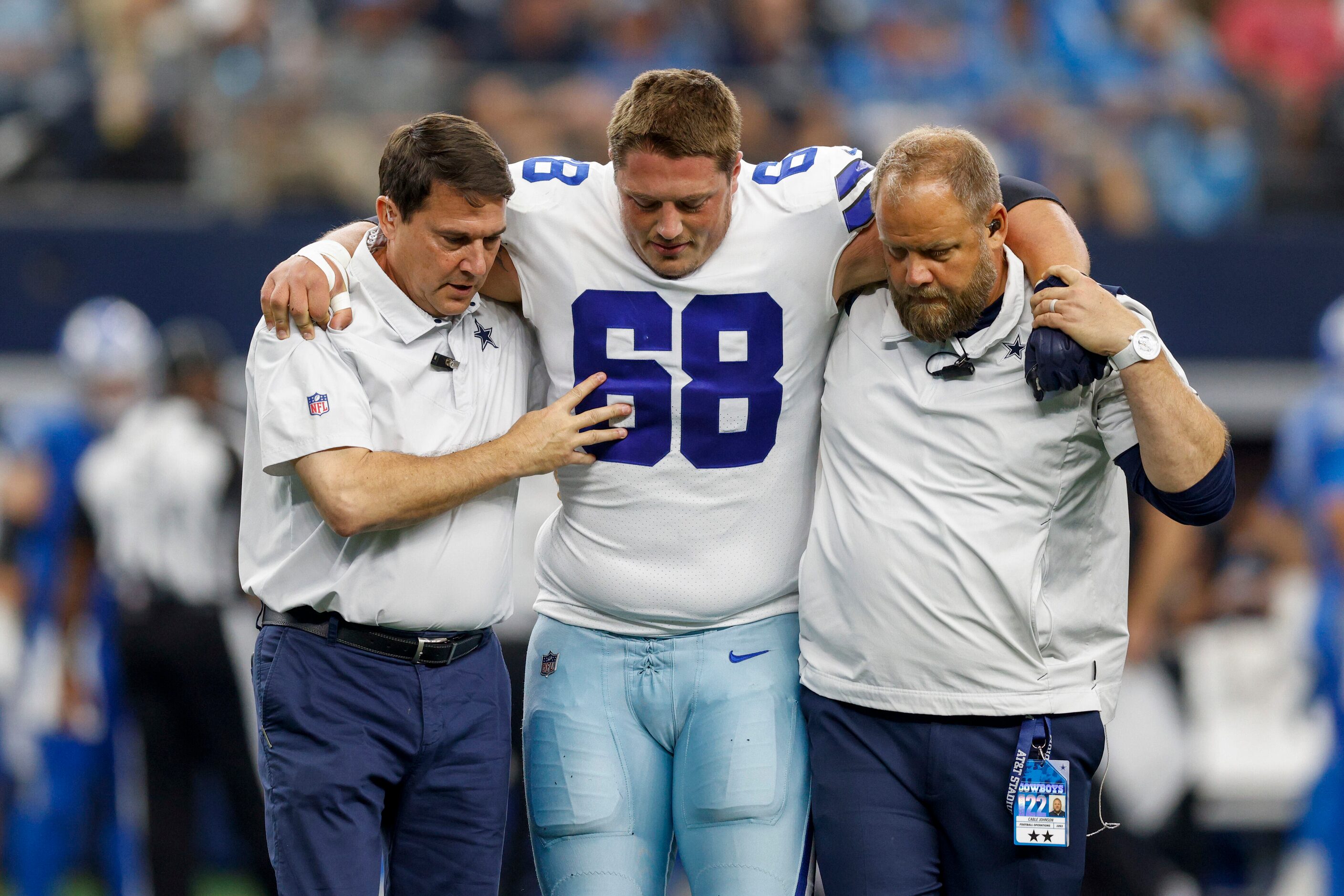 Dallas Cowboys guard Matt Farniok (68) is helped off the field after suffering an apparent...