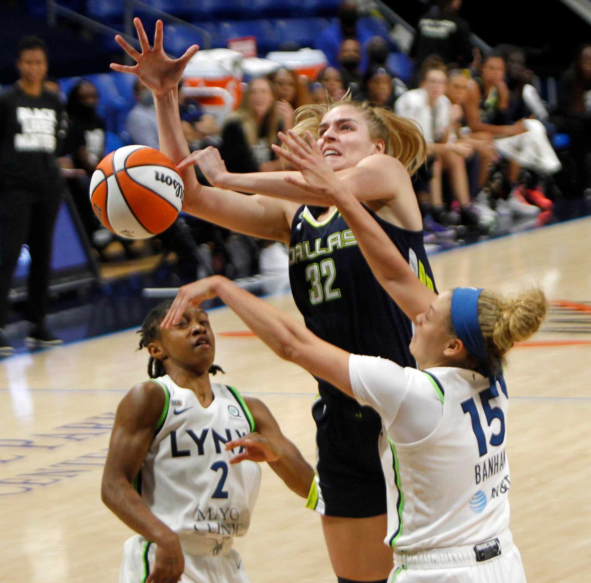 Dallas Wings center Bella Alarie (32) is fouled as she shoots against the defense of...