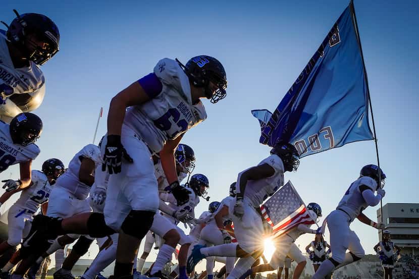 Trophy Club Byron Nelson players take the field to face Keller Fossil Ridge in a high school...