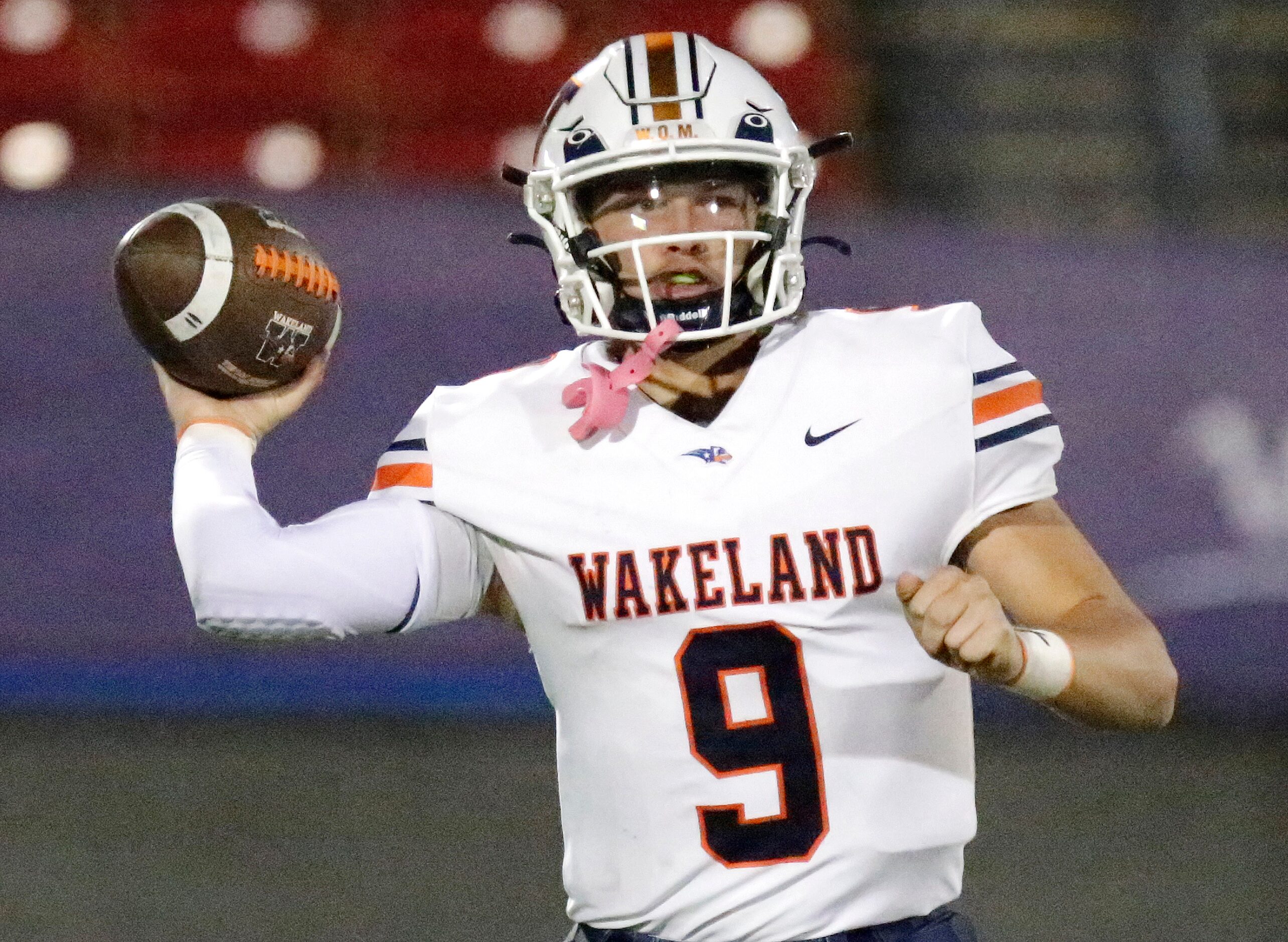 Wakealnd High School quarterback Brennan Myer (9) throws a pass during the first half as...