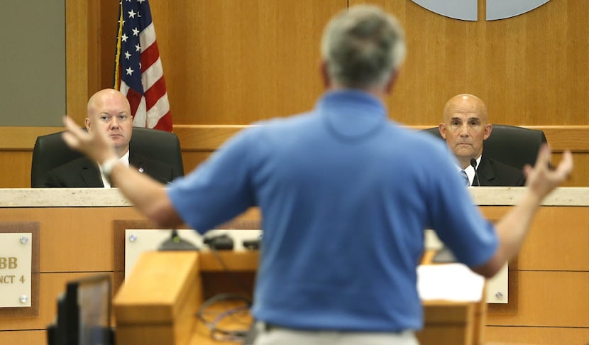 Commissioner Chris Hill (left) and County Judge Keith Self (right) listened to a speaker...