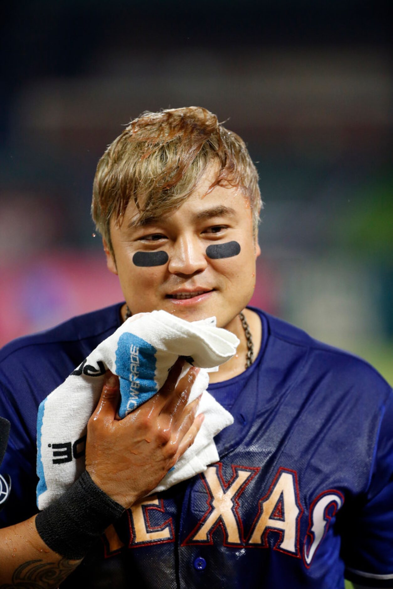 Texas Rangers' Shin-Soo Choo dries off after being doused with a sports drink by a teammate...