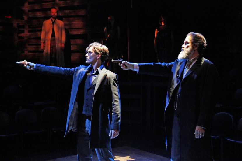 Actor Montgomery Sutton (John Wilkes Booth), left, has a gun pointed to his head by actor...
