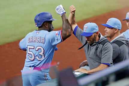 Texas Rangers right fielder Adolis Garcia (53) is congratulated by Texas Rangers manager...