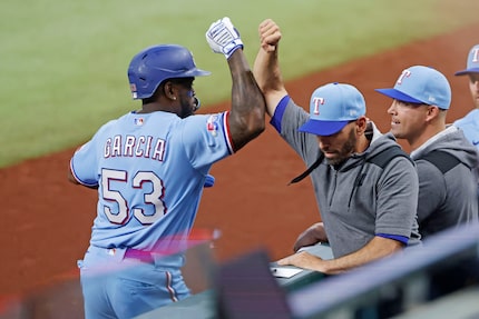 Texas Rangers right fielder Adolis Garcia (53) is congratulated by Texas Rangers manager...