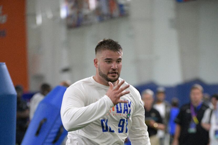 Defensive lineman Joey Ivie (91) runs through a drill during Florida's NFL Pro Day in...