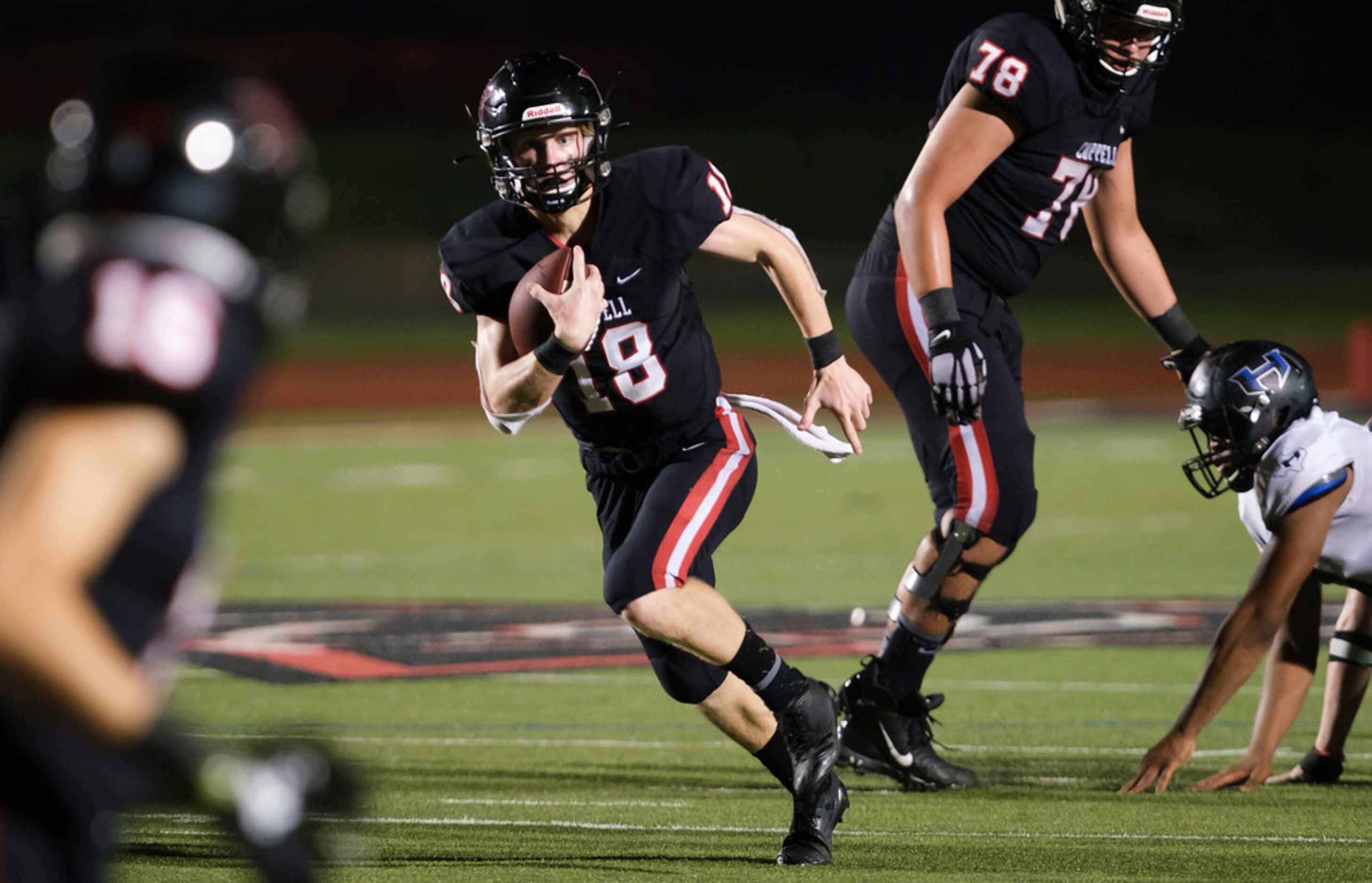 Coppell quarterback  Ryan Walker runs for a first down during the second half of a high...