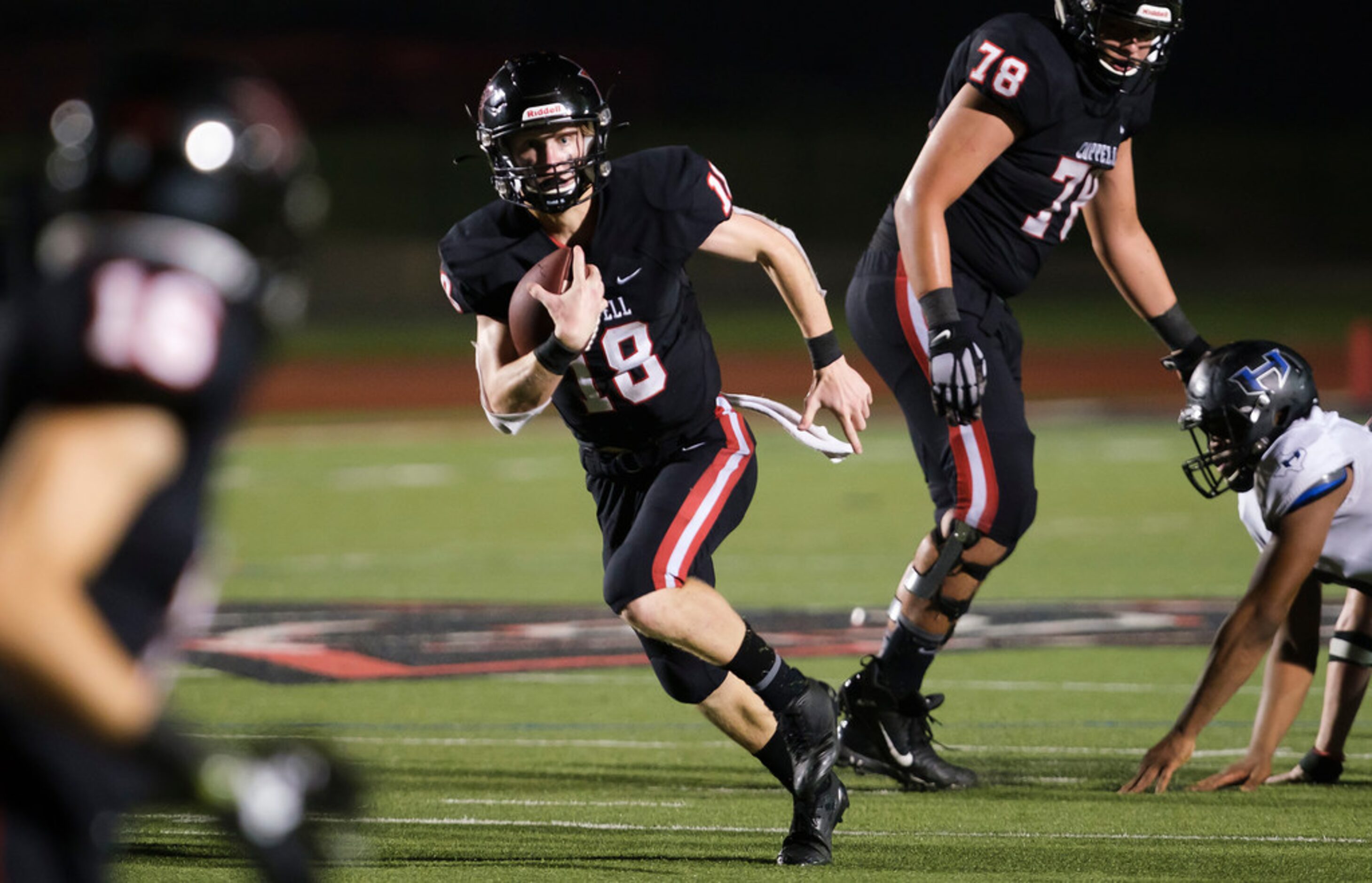 Coppell quarterback  Ryan Walker runs for a first down during the second half of a high...