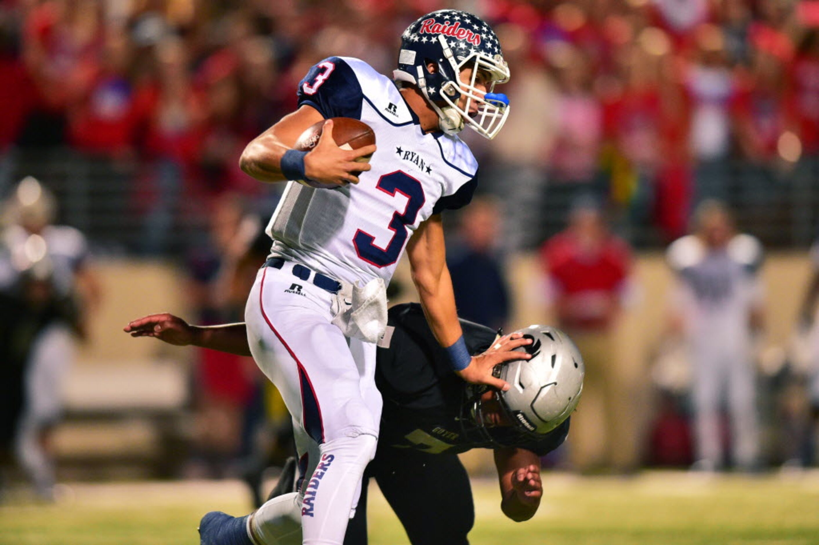 Ryan sophomore quarterback Spencer Sanders (3) holds back Guyer senior linebacker Dharrius...