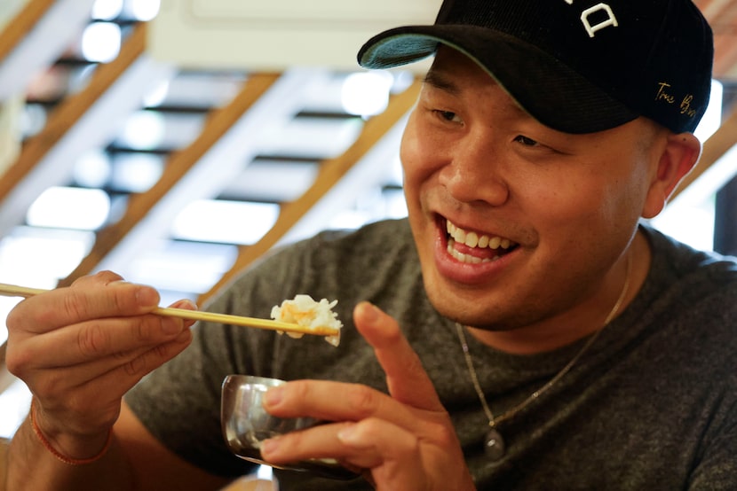 Vu Ly, founder of Asian Grub in DFDUB (DFW) Facebook group, reacts while working on a meal...